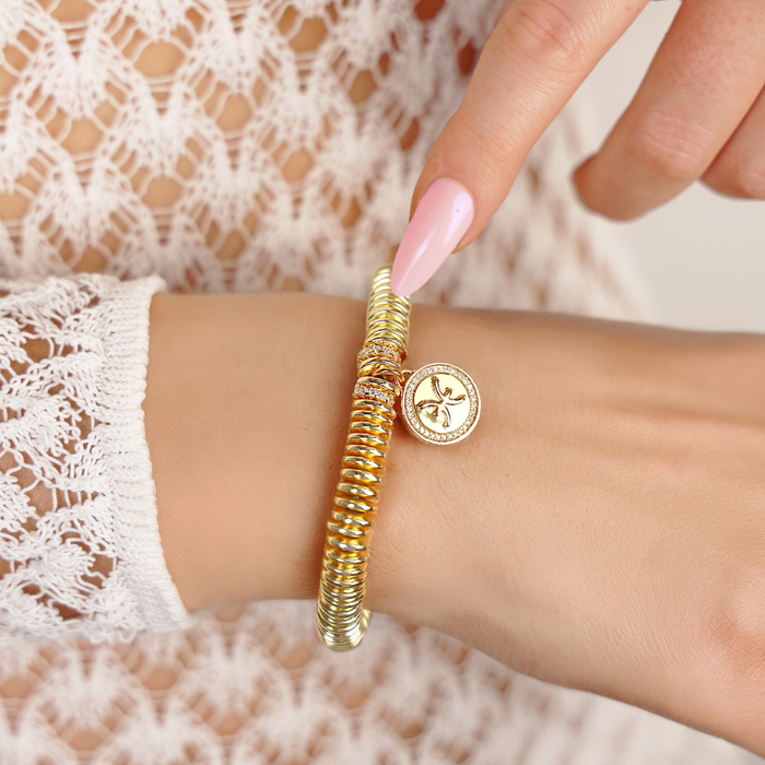 a person wearing a gold bracelet