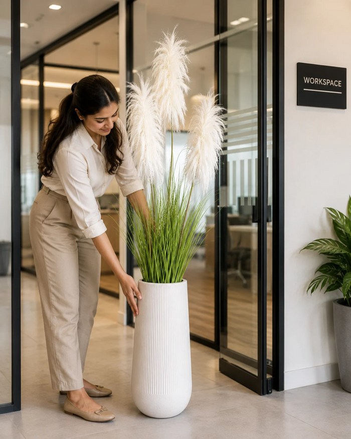 Artificial white feather grass plant in white ribbed vase pot with tall plumes
