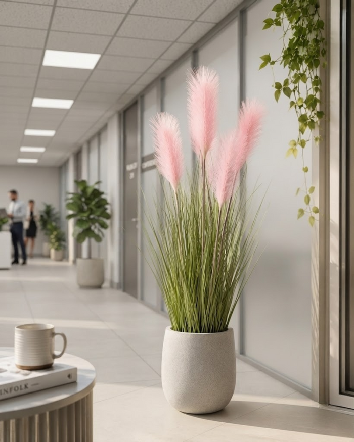 Artificial pampas grass with blush pink plumes, green stems, in a gray pot