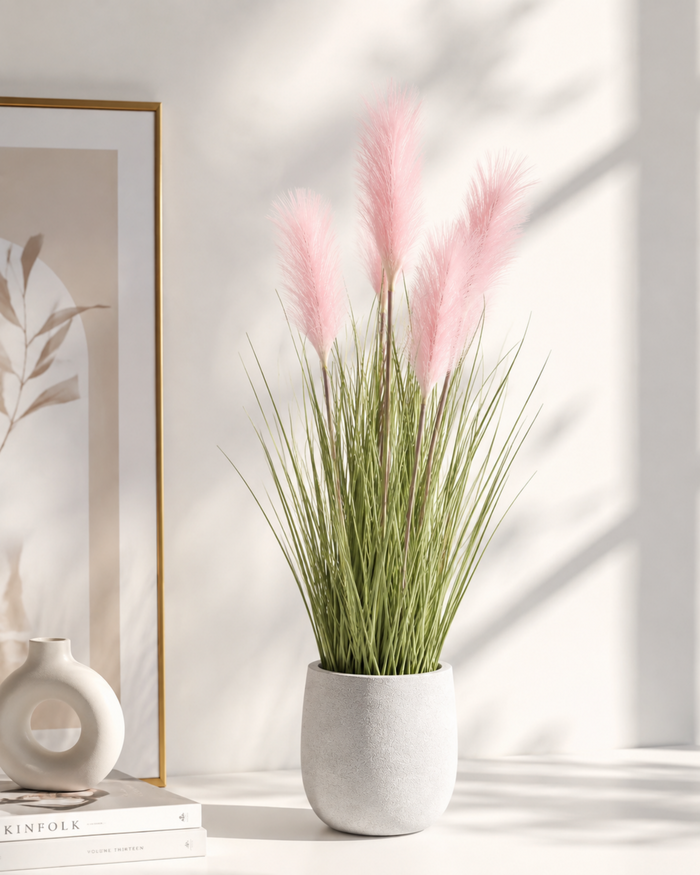 Artificial pampas grass in a gray pot with blush pink plumes and long green stems