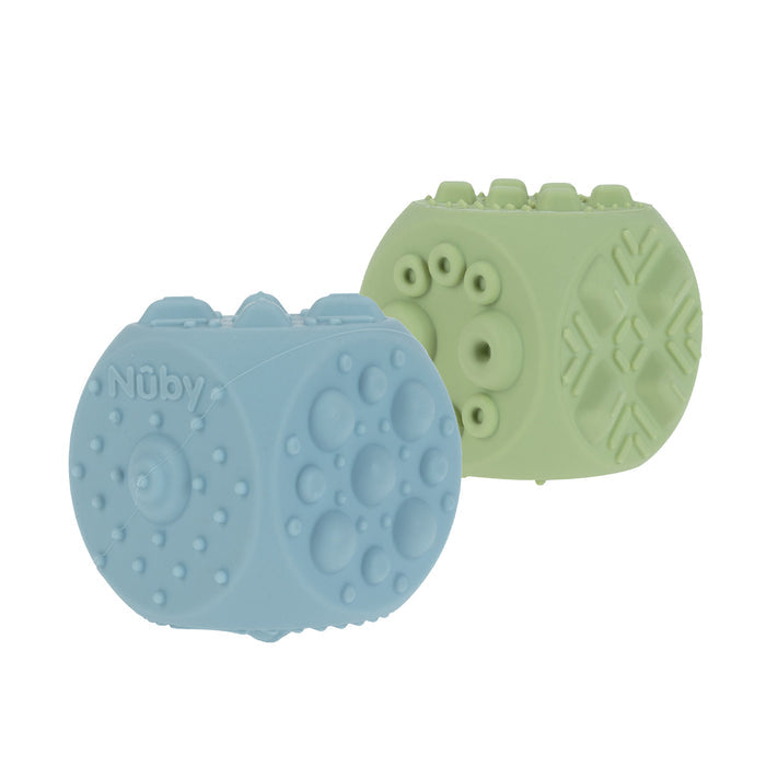Nuby US Silicone Popper Blocks (2 Pack) in light blue and green feature raised circles and geometric shapes, making them engaging baby sensory toys that help develop fine motor skills. The blue block displays the Nuby logo.