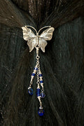 Silver butterfly hair hook ponytail holder with dangling blue crystal bead charms worn in dark ponytail, back view