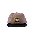 Former Slant F logo detail on brown cap close-up