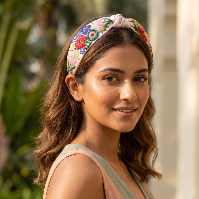 Embroidered floral headband with multicolor beading and sequin flowers on blush pink fabric