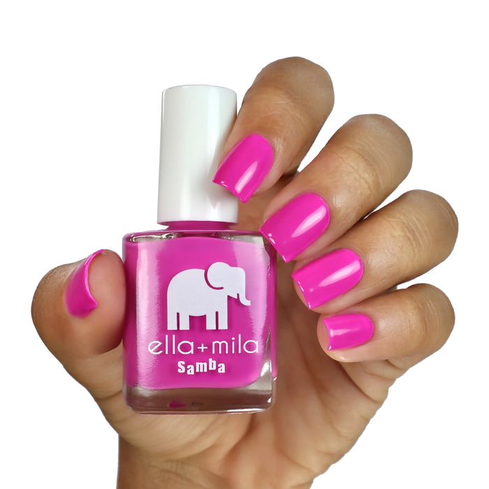 Sun Has Set purple-pink nail polish manicure on a light skin tone, holding the bottle