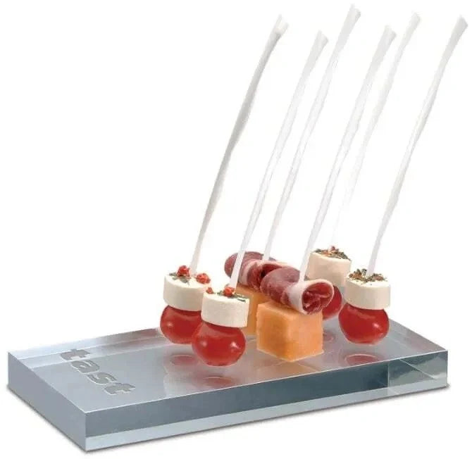 A pack of white plastic skewers, 7 inches long, displayed with food on them on a white background.