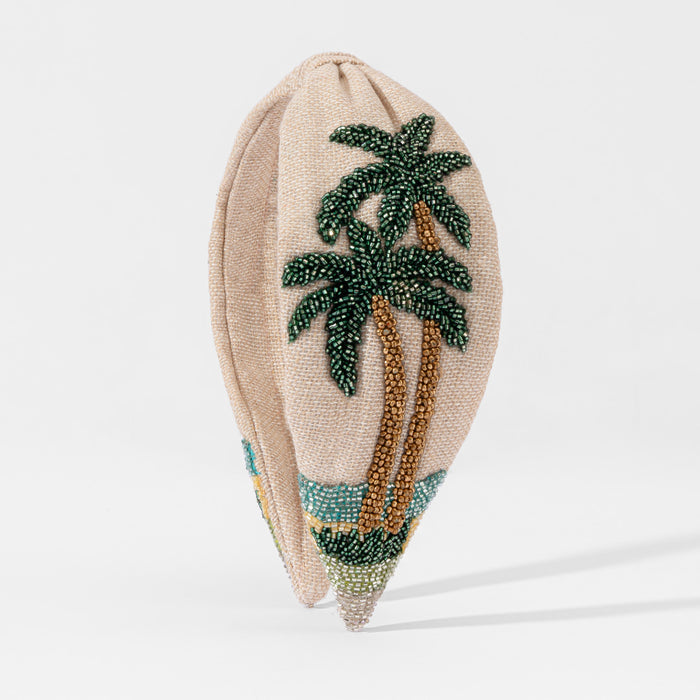 Hand-beaded tropical headband with emerald palm trees and gold sequin sand on beige linen base